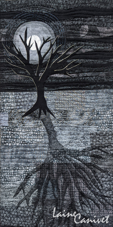 a greyscale quilt depicting a leafless tree silhouetted in front of a full moon